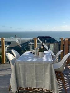 einen Tisch mit einem blauen und weißen Tischtuch auf einer Terrasse in der Unterkunft 28 North, Stunning Costal home with Generous Ferry Reduction in Ventnor