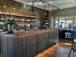 a bar in a restaurant with a wooden counter at Hotell Kristina in Sigtuna
