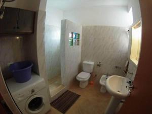 a small bathroom with a sink and a toilet at Casa Bahia 8 in Santa Maria