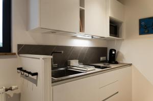 a kitchen with a sink and a counter top at Studio Les Terrasses de Kerangall in Brest