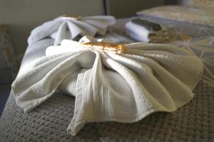 a white towel sitting on top of a bed at The Eastleigh in Skegness