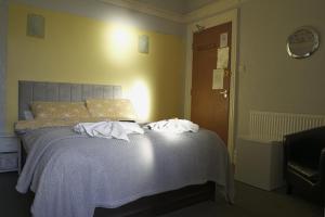 a bedroom with a bed with towels on it at The Eastleigh in Skegness