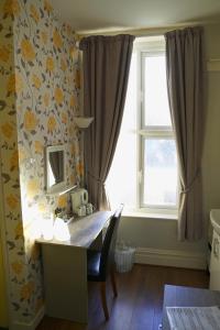 a dining room with a table and a window at The Eastleigh in Skegness
