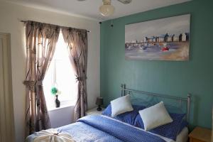 a bedroom with a bed and a window at The Eastleigh in Skegness