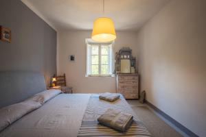 a bedroom with a large bed with two pillows on it at Villa Pietra Viva in Lucignano +30 photos