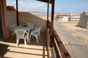 a table and chairs on the balcony of a house at Casa Bahia 10 Grande Penthouse in Santa Maria