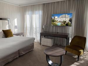 Un ou plusieurs lits dans un hébergement de l'établissement Hôtel Le Canberra