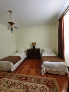 En eller flere senge i et værelse på Casa Jean Pineau