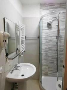 a bathroom with a sink and a glass shower at Xixi B&B in Mestre