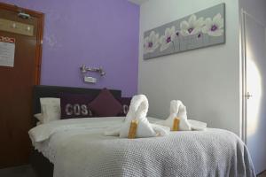 two stuffed animals are sitting on a bed at The Eastleigh in Skegness