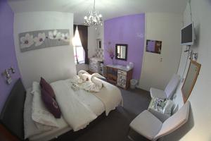 a hospital room with a bed and a chair at The Eastleigh in Skegness