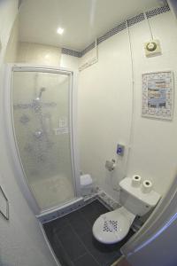 a small bathroom with a shower and a toilet at The Eastleigh in Skegness