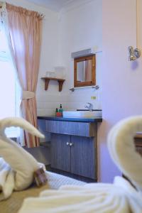 a bathroom with a sink and a mirror at The Eastleigh in Skegness