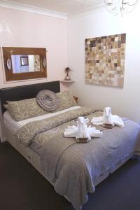 a bedroom with a bed with towels on it at The Eastleigh in Skegness