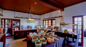 a kitchen with a table with baskets of food on it at Kithala Resort - Thema Collection in Tissamaharama