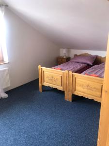 a bedroom with a wooden bed in a room at Apartmány Diana in Lužice