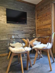 two glass chairs and a table in a room at Ecrin des Glaciers Combloux in Combloux