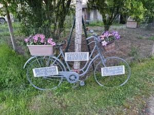 Una bicicleta estacionada al lado de una casa con letreros. en La Bastide du Moulin - Mont St Michel, en Moidrey