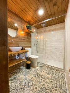 a bathroom with a shower and a toilet and a sink at Mountain Eco Shelters 2 in Funchal