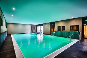 a large swimming pool in a hotel room at Hotel Zugbrücke Grenzau GmbH in Höhr-Grenzhausen