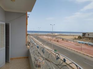 a balcony with a view of the beach at Qussier sea view apartment in Quseir