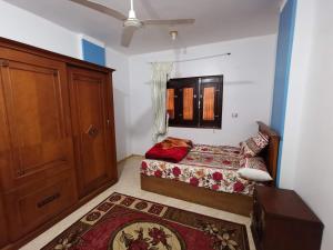 a bedroom with a bed and a wooden door at Qussier sea view apartment in Quseir