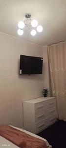a bedroom with a flat screen tv on the wall at Xixi B&B in Mestre