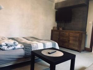 a room with two beds and a table with a tv at Apartament u Doroty in Augustów