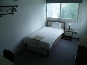 מיטה או מיטות בחדר ב-Datacom Guest House