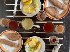 a table with plates of food and bowls of dips at Om yoga Shala Beruwala - Yoga & Sound Healing in Beruwala