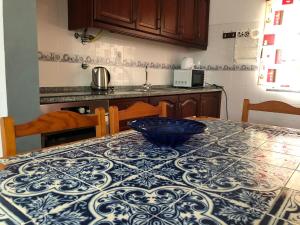 a kitchen with a table with a blue bowl on it at Camping Villa Park Zambujeira do Mar in Zambujeira do Mar