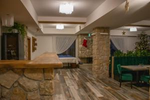 a room with a stone wall and a table at Vale Humor Residence in Mănăstirea Humorului