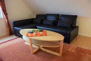 a living room with a table and a couch at Lindensweet in Lindwedel