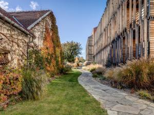 a stone path between two buildings next to a building at Wellness Hotel Volarik in Mikulov