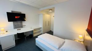 a hotel room with a bed and a desk at Creativ Park Hotel in Nuremberg