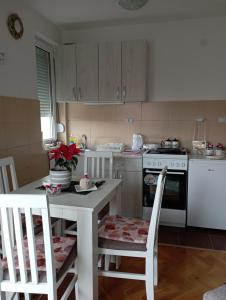a kitchen with a table and chairs and a stove at Агни in Vrnjačka Banja