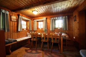 a dining room with a table and chairs in a cabin at Almliesl EMBA-605 in Embach