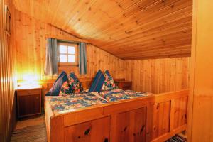 a bed in a wooden room in a cabin at Almliesl EMBA-605 in Embach