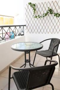 a table and two chairs and a glass table and chairs at Guest Apartments in Limassol