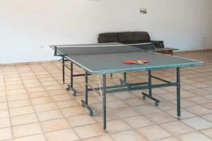 a ping pong table with a pair of scissors on it at Guest Apartments in Limassol