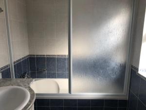 a bathroom with a shower with a tub and a sink at Camping Villa Park Zambujeira do Mar in Zambujeira do Mar