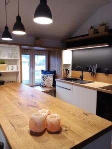 two pieces of bread sitting on a wooden table in a kitchen at Apartmán Jeseníky in Karlovice