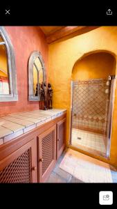 a bathroom with a large shower with a mirror at La Dulcinea in Sotogrande