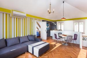 a living room with a blue couch and a table at Apartment Art Dubrovnik in Dubrovnik