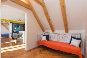 a living room with a red bench in a room at Apartment Art Dubrovnik in Dubrovnik