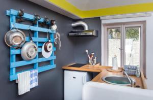 a kitchen with a sink and a blue wall at Apartment Art Dubrovnik in Dubrovnik