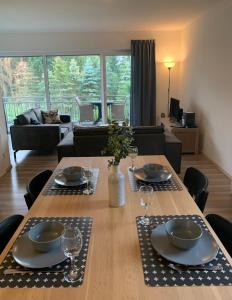 a living room with a table with plates and wine glasses at Appartement Rothaarsteig in Medebach