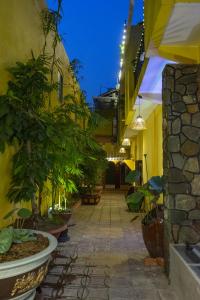 a courtyard of a building with potted plants at La'ANh Boutique Stay in Can Tho