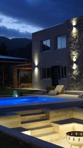 a house with a swimming pool at night at Divina Montaña in Mendoza