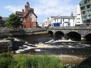 a bridge over a river in a city at Lilac Manor in Sligo